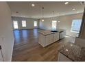 Open concept kitchen boasts a granite island with a sink and stainless steel dishwasher at 17 E Victory View Ter, Smithfield, NC 27577