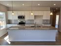 Bright kitchen features a granite island, modern appliances, and ample cabinet space at 17 E Victory View Ter, Smithfield, NC 27577