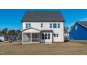 The rear exterior of a home featuring a screened porch and spacious backyard at 2006 Anna Lilley Dr # 72, Fuquay Varina, NC 27526