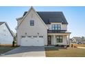 Beautiful new construction home with a spacious two-car garage, manicured lawn, and covered entry at 2006 Anna Lilley Dr # 72, Fuquay Varina, NC 27526