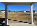 View of a large, undeveloped backyard from a covered porch at 216 Vili Dr, Broadway, NC 27505