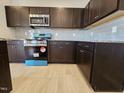Kitchen with wooden cabinets, stainless steel appliances and gray backsplash at 216 Vili Dr, Broadway, NC 27505