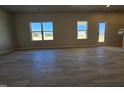 Bright living room featuring hardwood floors and natural light from two windows at 216 Vili Dr, Broadway, NC 27505