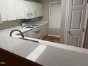 White cabinets, granite countertops, and stainless steel sink in kitchen at 2232 Ventana Ln, Raleigh, NC 27604