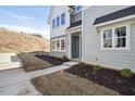 Townhome exterior showcasing gray siding and landscaping at 600 Hillfarm Dr, Wake Forest, NC 27587