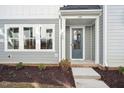 Modern front door with a covered entryway and landscaping at 600 Hillfarm Dr, Wake Forest, NC 27587