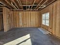 Unfinished room with exposed framing, electrical wiring, and plumbing at 65 Vili Dr, Broadway, NC 27505