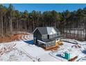 Two-story house on wooded lot with snowy ground at 80 Purslane Dr, Franklinton, NC 27525