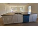 Bright, open kitchen featuring a central island, stainless steel sink, and modern appliances at 87 Vili Dr, Broadway, NC 27505
