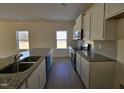 Modern kitchen featuring granite counters, stainless appliances, and ample cabinet space at 87 Vili Dr, Broadway, NC 27505