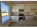 Well-equipped kitchen with white cabinets, granite countertops, and stainless steel appliances at 87 Vili Dr, Broadway, NC 27505