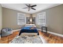 Bright bedroom with a blue bedspread and hardwood floors at 909 E F St, Butner, NC 27509