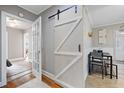 Small dining area with a barn door leading to the kitchen at 909 E F St, Butner, NC 27509