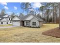 New construction home with stone and siding exterior, and a large backyard at 101 Prairie Dog Dr, Louisburg, NC 27549