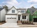 Attractive two-story home with a covered front porch, attached garage, and a well-maintained lawn at 108 Bearwallow Forest Way, Wendell, NC 27591