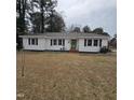 Charming single-story home with white siding, black shutters, a green door, and a spacious front yard at 1309 Eastern Avenue Ave, Rocky Mount, NC 27801