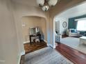 Inviting living room features hardwood floors, neutral paint, and arched doorways to other living spaces at 1309 Eastern Avenue Ave, Rocky Mount, NC 27801