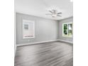 Bright living room featuring gray vinyl plank flooring and a ceiling fan at 157 Rainbow Dr, Dunn, NC 28334