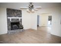 Spacious living room with a stone fireplace and wood-look flooring at 1924 Edgeleaf Dr, Willow Springs, NC 27592