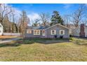 Gray house with white shutters and a spacious lawn at 205 Coachman Dr, Garner, NC 27529