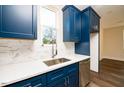 Modern kitchen with white countertops and blue cabinets at 2407 Hart Street # B, Durham, NC 27703