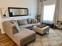 Spacious living room featuring a sectional sofa and large window at 26 Wildberry Ct, Rocky Mount, NC 27804