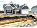 New single-Gathering home showcasing a modern design with two-car garage and professional landscaping at 260 Olivia Crossing Ct # 9, Four Oaks, NC 27524
