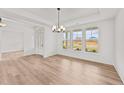 Elegant dining room featuring recessed lighting, wood floors, and large windows with neighborhood views at 467 Ravensworth Dr, Garner, NC 27529