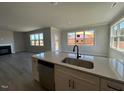 Open kitchen features quartz counters and stainless steel appliances, perfect for cooking at 505 Ravensworth Dr, Garner, NC 27529