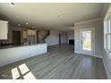 Open-concept living room showcasing modern flooring and access to kitchen and stairs at 505 Ravensworth Dr, Garner, NC 27529