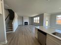 Open-concept living room showcasing fireplace, natural light, and modern flooring at 505 Ravensworth Dr, Garner, NC 27529