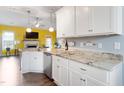 Bright kitchen features white cabinets, granite countertops, stainless steel appliances, and modern lighting at 58 Northview Dr, Middlesex, NC 27557