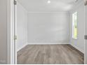 Empty room with wood floors, white walls, and a window at 60 Accord Dr, Youngsville, NC 27596