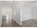 Bright hallway featuring wood floors and an open view of the kitchen at 60 Accord Dr, Youngsville, NC 27596
