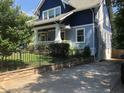 Side view showcasing the home's architectural details and driveway at 807 E Edenton St, Raleigh, NC 27601