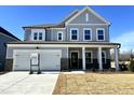Two-story house with gray siding, brick accents, and a two-car garage at 100 S Stonemill Trl # Homesite 234, Clayton, NC 27520