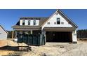 New construction home featuring a two-car garage and a covered front porch at 107 Pretty Run Branch Ln, Wendell, NC 27591