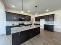 Modern kitchen with stainless steel appliances, granite countertops and a large island at 107 Pretty Run Branch Ln, Wendell, NC 27591
