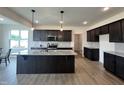 Spacious kitchen with dark cabinets, granite countertops and a large center island at 107 Pretty Run Branch Ln, Wendell, NC 27591