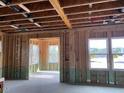 New home construction features an open floor plan with large windows at 109 Magma Ln, Holly Springs, NC 27540