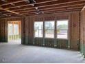 New home construction features an open floor plan with large windows at 109 Magma Ln, Holly Springs, NC 27540