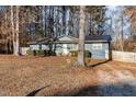 Gray Ranch style home with a metal roof, and landscaping at 2505 Friendly Trl, Raleigh, NC 27610