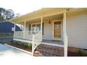 Front porch with brick steps and wooden railings at 2615 Barwick Dr, Durham, NC 27704