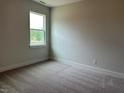Cozy bedroom with plush carpet and a large window offering ample natural light at 292 Weddington Way, Benson, NC 27504