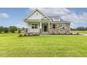 Beautiful home boasts a manicured lawn and an inviting entrance at 292 Weddington Way, Benson, NC 27504