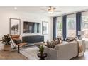 Cozy living room with comfortable seating, a large TV, and plenty of natural light at 3391 Mission Olive Pl, New Hill, NC 27562