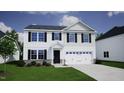 Attractive two-story home featuring a stone foundation, black shutters, and an attached two car garage at 45 Calabria Ct, Franklinton, NC 27525