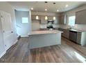 Eat in kitchen with center island, stainless appliances, and view to stairs at 45 Calabria Ct, Franklinton, NC 27525