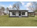 White house with black trim, covered porch, and a spacious yard at 521 Mill St, Smithfield, NC 27577