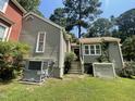 View of the home's exterior displaying well-maintained siding and lush green lawn at 5718 Sentinel Dr, Raleigh, NC 27609